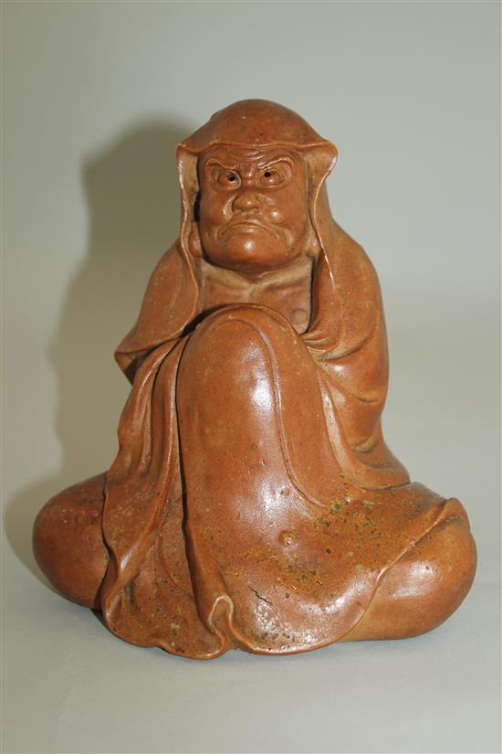 A Japanese stoneware seated figure of Daruma, 19th century, 18.5cm